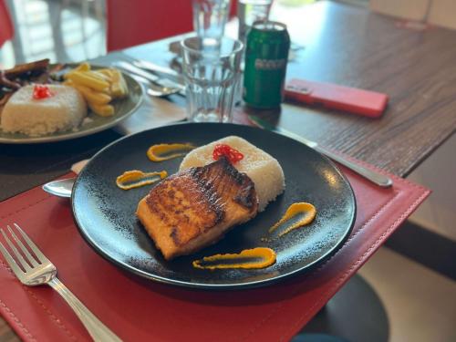 a black plate of food on a table with food at ibis Puerto Montt in Puerto Montt