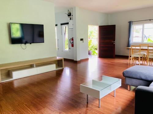 a living room with a couch and a tv at Lanta sky pool villa in Ko Lanta