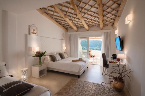a large bedroom with a bed and a living room at Hotel Moresco in Santa Teresa Gallura