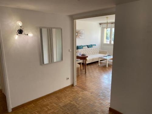 a living room with a couch and a table at Appartement calme Stade/plage in Marseille