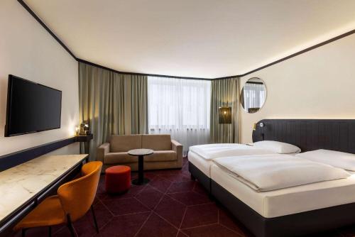 a hotel room with a bed and a chair at Vienna House by Wyndham Diplomat Prague in Prague