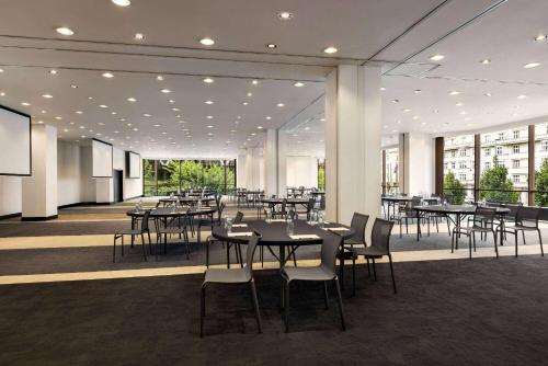 a dining room with tables and chairs in a building at Vienna House by Wyndham Diplomat Prague in Prague