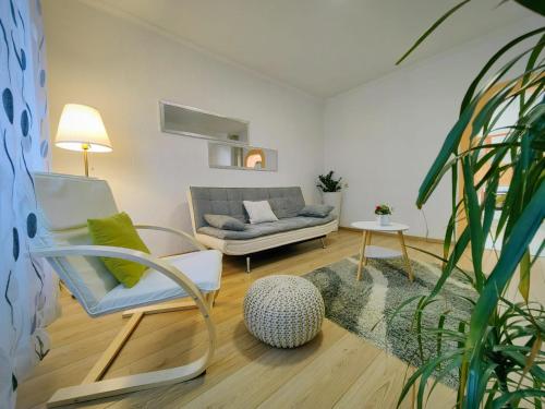 a living room with a couch and a chair at Apartmani Sabina in Fužine