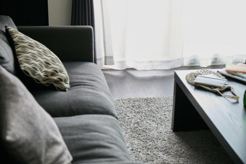 a living room with a couch and a coffee table at PINN-N4E2Ⅰ in Sapporo