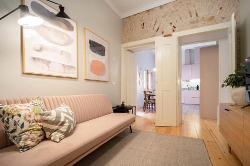 a living room with a couch and a table at Entre Ruas Apartments in Coimbra
