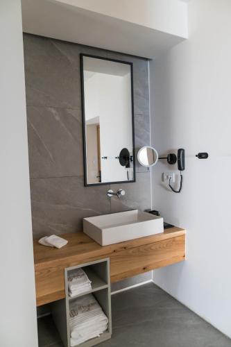 a bathroom with a sink and a mirror at Alissachni SeaSide Hotel in Derveni