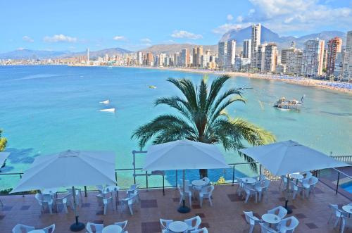 a beach filled with lots of colorful umbrellas at Hotel Lido in Benidorm
