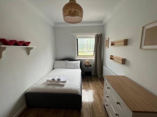 a small bedroom with a bed and a window at Stylish Flat With River View in Dublin