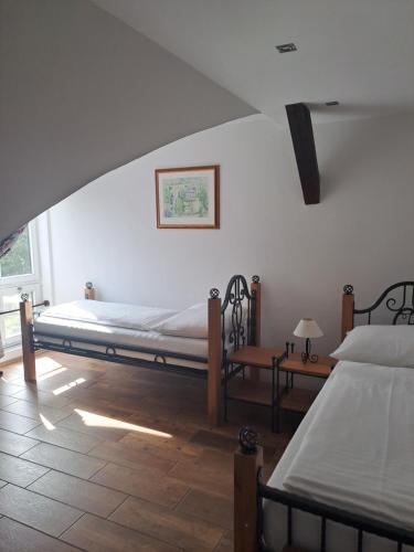 a bedroom with two beds and a window at Lesní Hotel Peršlák in Nová Bystřice