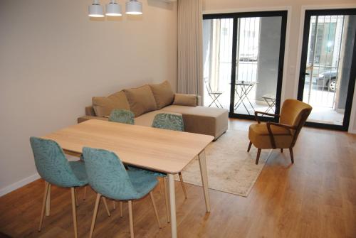 a living room with a table and chairs and a couch at Gaia Loves You - Serra do Pilar in Vila Nova de Gaia
