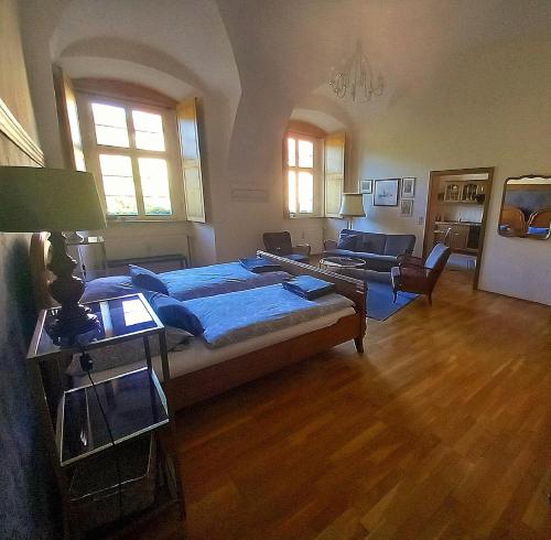 a bedroom with a large bed and a living room at Klostermühle in Lichtenfels