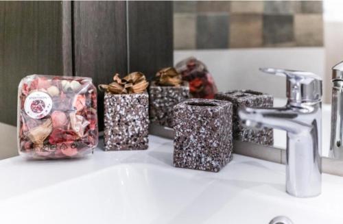 a bathroom counter with several gift boxes on a sink at Napuletanata in Naples