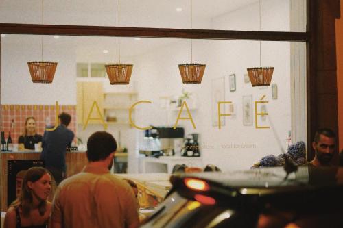 a group of people standing in a store at Jaca Hostel Funchal in Funchal