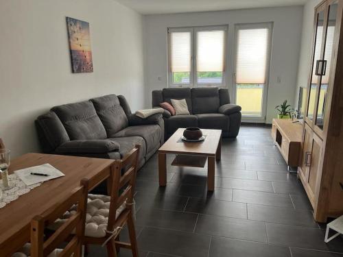 a living room with a couch and a table at Gästewohnung KL. WZL 38_7 in Klein Wanzleben