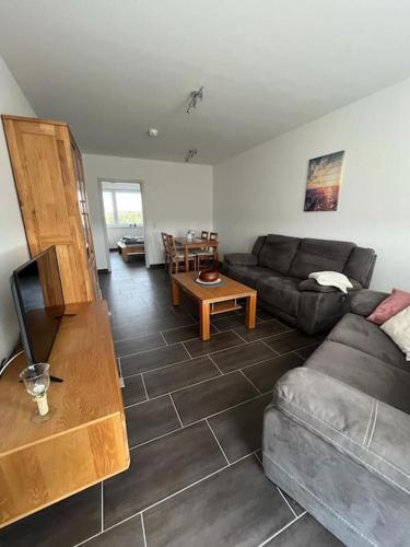 a living room with a couch and a table at Gästewohnung KL. WZL 38_7 in Klein Wanzleben