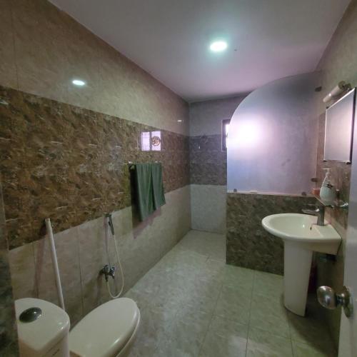 a bathroom with a sink and a toilet and a sink at Private Suite F-10 Islamabad in Islamabad
