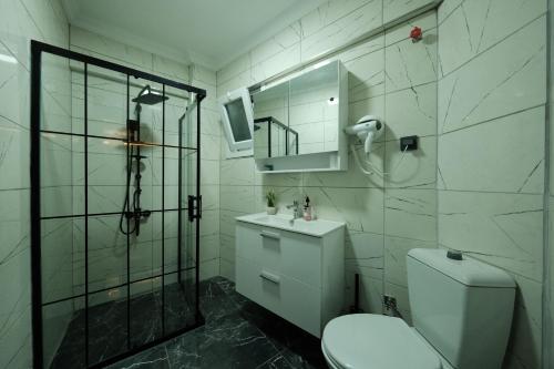 a bathroom with a shower and a toilet and a sink at Karaköy in Karaköy Hotel in Istanbul