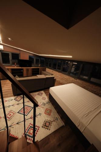 a room with two beds and a couch and a rug at Karaköy in Karaköy Hotel in Istanbul