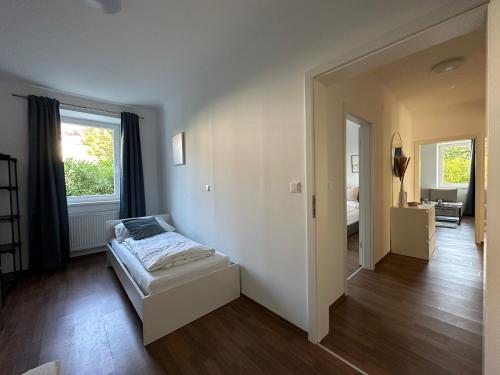 - une chambre avec un lit au milieu d'une pièce dans l'établissement FeelHome-GolfClub-Terrasse-6 Gäste-WiFi-Smart TV, à Ebreichsdorf