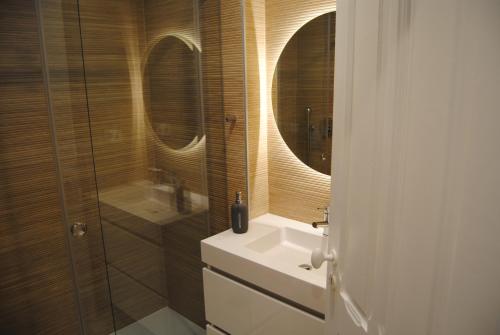 a bathroom with a sink and two mirrors at Gaia Loves You - Ponte D. Luis in Vila Nova de Gaia