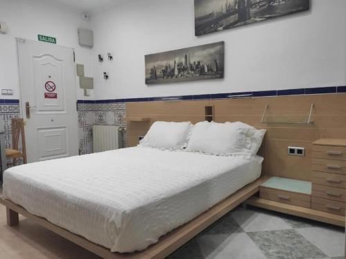 Ένα ή περισσότερα κρεβάτια σε δωμάτιο στο EL RINCONCITO DEL CABANYAL VALENCIA