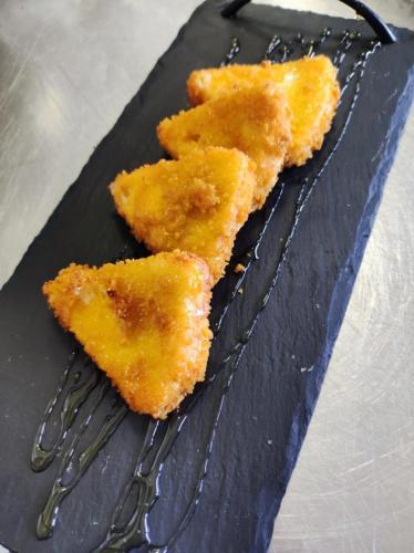 two pieces of food sitting on a black plate at I Segreti del Borgo in Penna in Teverina