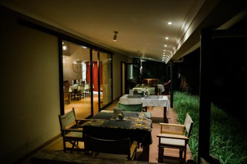 a dining room with a table and chairs on a patio at Domiya Estate Ltd in Dodoma