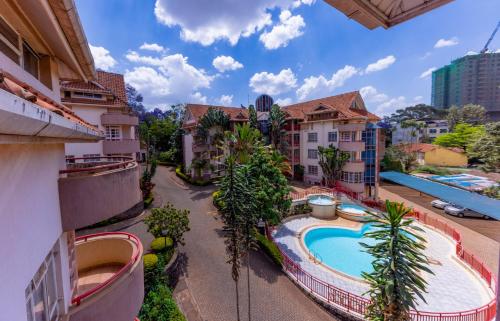 an overhead view of a resort with a swimming pool at Cosy and accessible 1BR penthouse with terrace in Nairobi