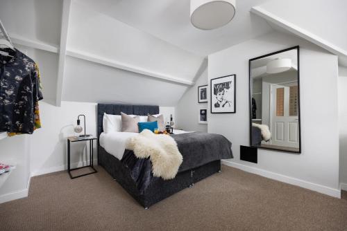 a bedroom with a bed with a large mirror at Central Plymouth 1 Bedroom Apartment - Sleeps 5 - Habita Property in Plymouth