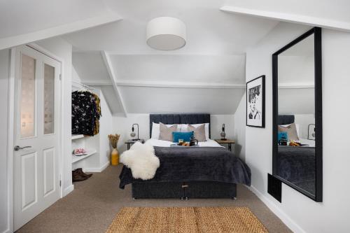 a bedroom with a bed with a large mirror at Central Plymouth 1 Bedroom Apartment - Sleeps 5 - Habita Property in Plymouth