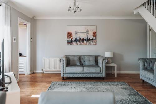 a living room with two chairs and a couch at Stylish spacious home in Redcar in Redcar