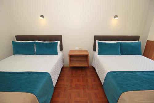 Postel nebo postele na pokoji v ubytování Hostal Plaza by Elvita