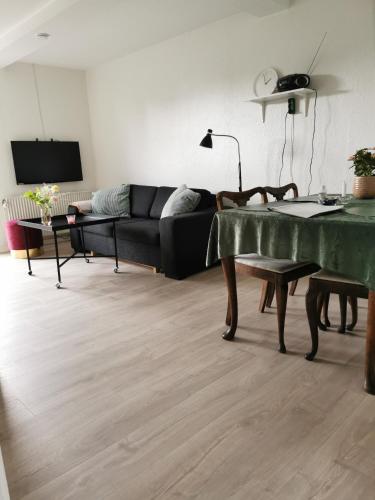 a living room with a couch and a table at Håstrups Natur Perle in Fåborg