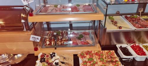 a buffet with many different types of food on display at Hotel Kreis Residenz München in Munich