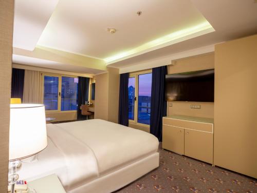 a hotel room with a bed and a television at DoubleTree by Hilton Izmir - Alsancak in Izmir