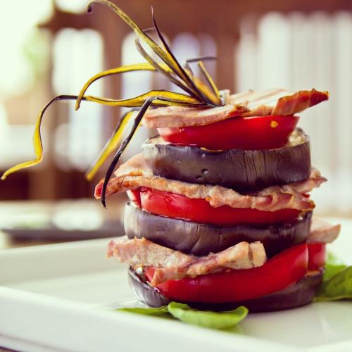a stack of vegetables on a white plate at Quartara Boutique Hotel in Panarea
