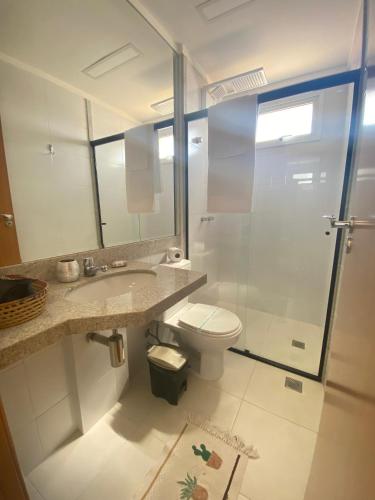 a bathroom with a shower and a toilet and a sink at Elegante apto de 2/4 2004 in Goiânia