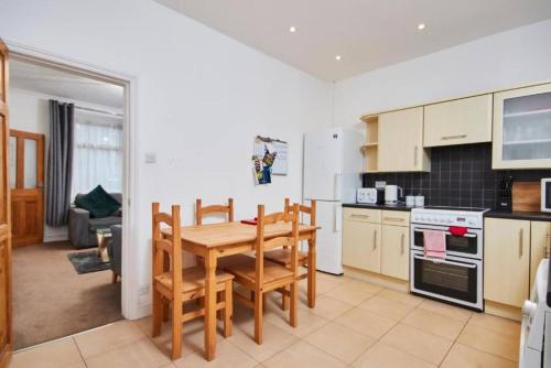 a kitchen with a wooden table and chairs in a kitchen at Beautiful 3 Bed Abode in The Heart of Skipton in Skipton