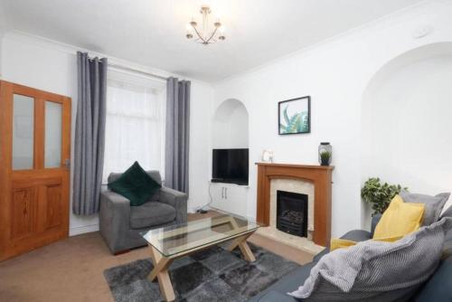 a living room with a couch and a fireplace at Beautiful 3 Bed Abode in The Heart of Skipton in Skipton