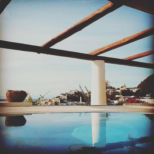 a swimming pool with a view of a city at Quartara Boutique Hotel in Panarea