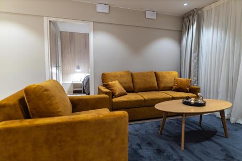 a living room with a couch and a table at Royal Roi Apartments in Rovaniemi