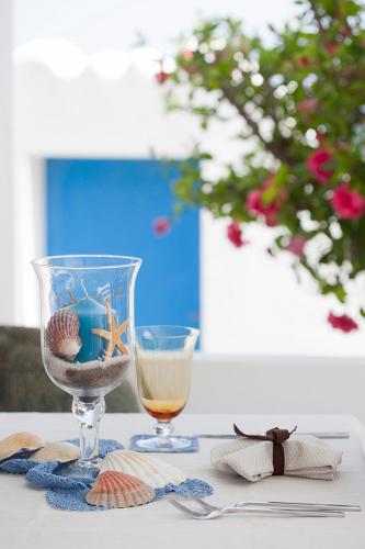 a table with a wine glass and a glass with a drink at Quartara Boutique Hotel in Panarea