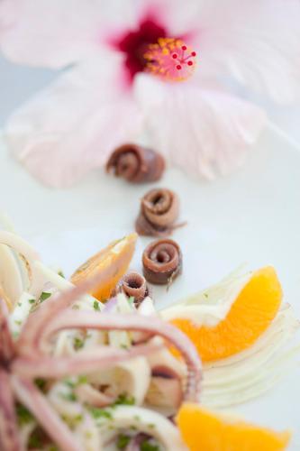 a plate of food with orange slices and nuts at Quartara Boutique Hotel in Panarea