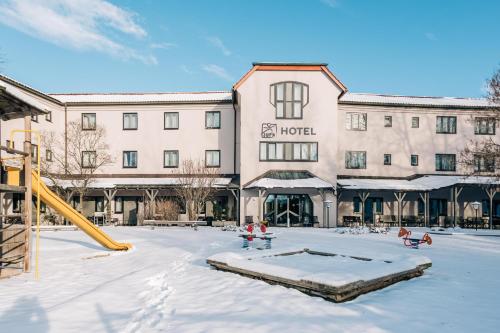 a hotel with a playground in the snow at JUFA Hotel Maria Lankowitz in Maria Lankowitz
