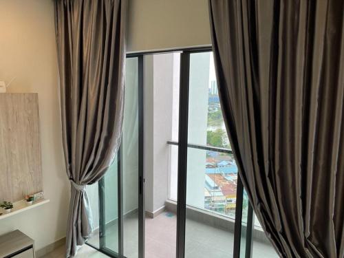 Zimmer mit schwarzen Vorhängen und einem großen Fenster in der Unterkunft Skyville 8 @ Benteng in Kuala Lumpur