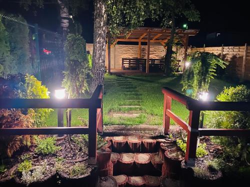 a view of a garden at night with a bench at Penzion Larion in Kráľová Lehota