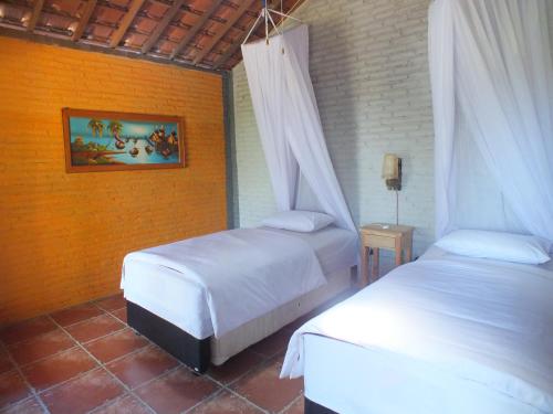 Postel nebo postele na pokoji v ubytování Cocohuts Hotel