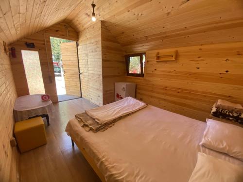 a bedroom with a bed in a wooden cabin at Anabella Sevan - Коттеджи рядом с озером Севан (Sevanavanq) in Sevan
