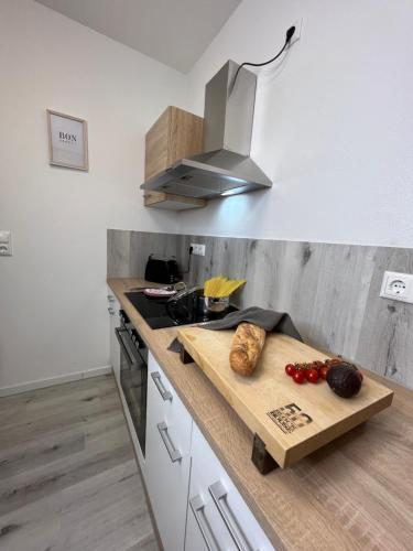 a kitchen with a wooden cutting board on a counter at Home Inn Apartments - 201 in Minden