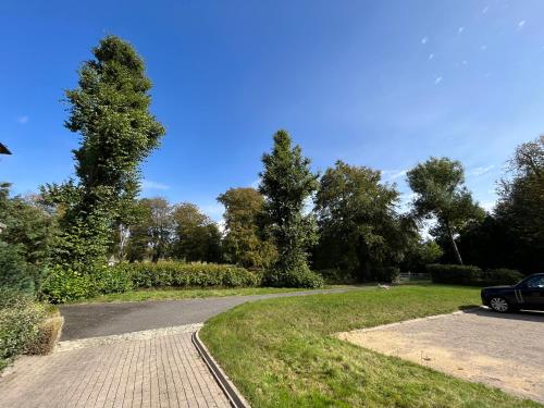 a driveway with a car parked next to a tree at Yu’s Guest House in Sevenoaks